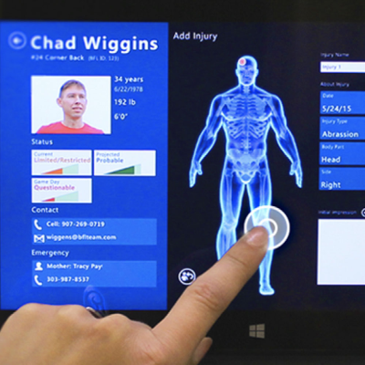 person touching medical record touch screen device