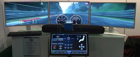 Immersive racing game setup with three screens, a soundbar, and a control panel.