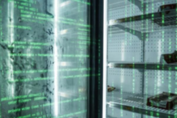 Grocery store refrigerator with glass doors displaying green digital code, shelves hold dark objects.